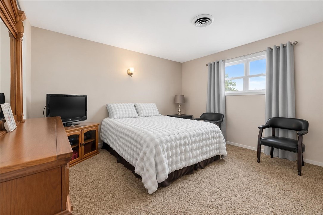 9675 County Road 325 Mathis, TX 78368 - Photo 24 of 29 a bedroom with a bed and a chair