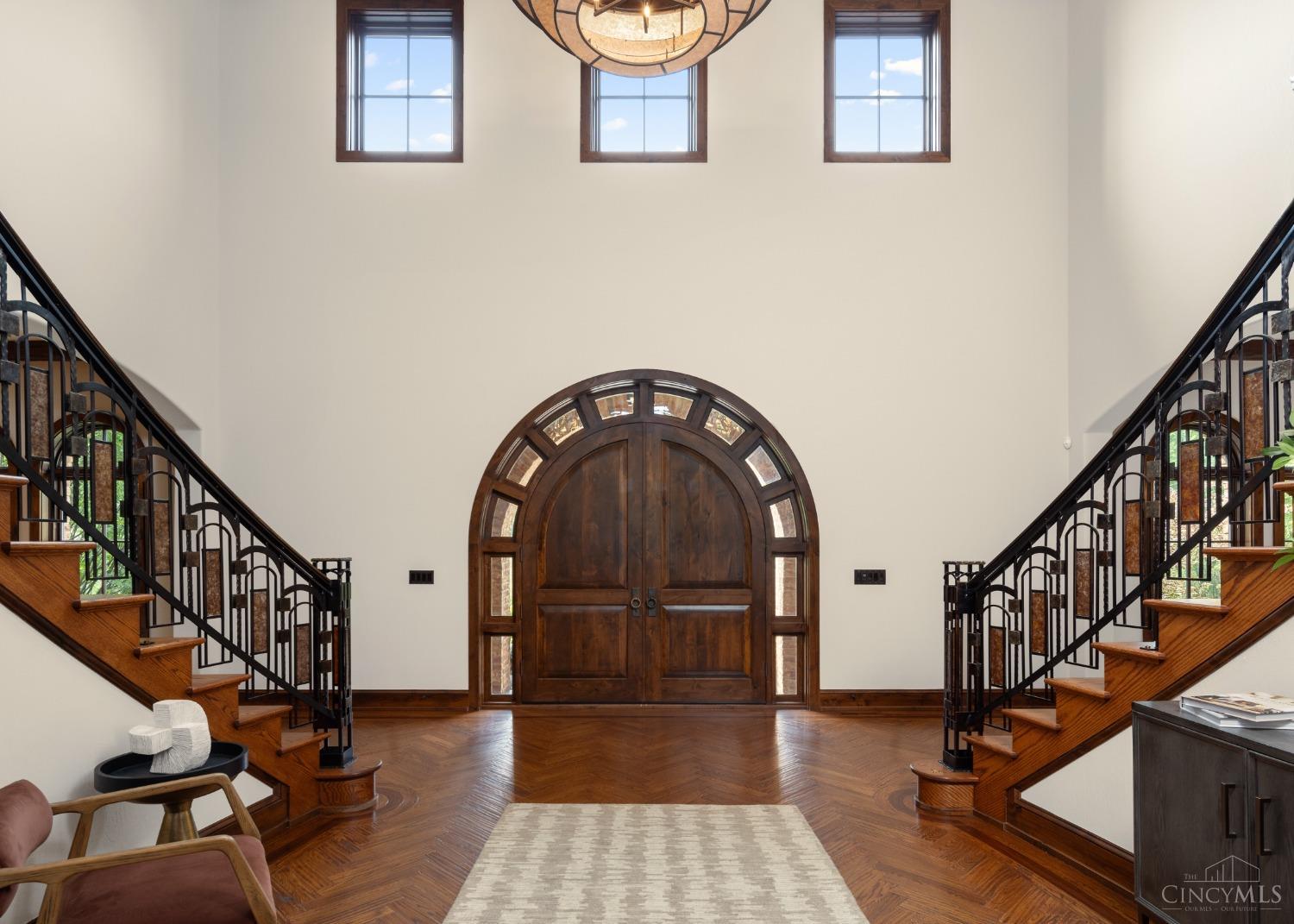 5900 Park Road Cincinnati, OH 45243 - Photo 7 of 50 Exquisite Entry (17’ X 13’) This grand entry features a custom arched double door, massive mica chandelier, and 21’6” ceiling. Other features include distressed oak hardwood flooring with custom herringbone pattern, grand dual staircase, and mica, bronze, and steel handrail.