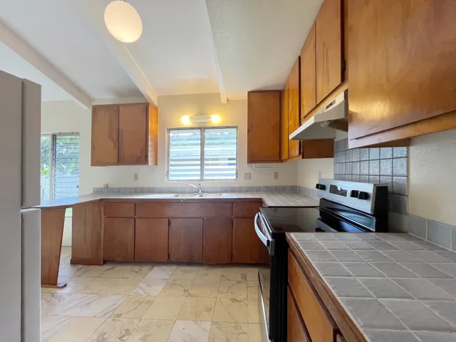 a kitchen with stainless steel appliances granite countertop a sink and cabinets