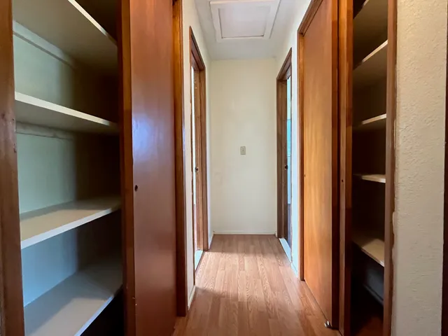 a view of a hallway with wooden floor