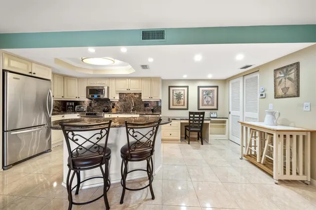 a spacious bedroom with a bed and a chandelier