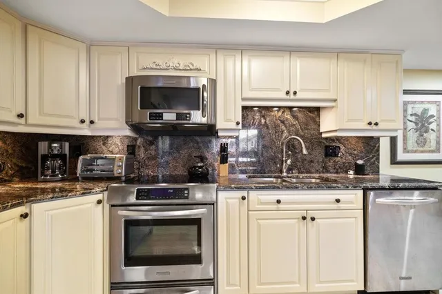 a spacious bedroom with a bed and a chandelier