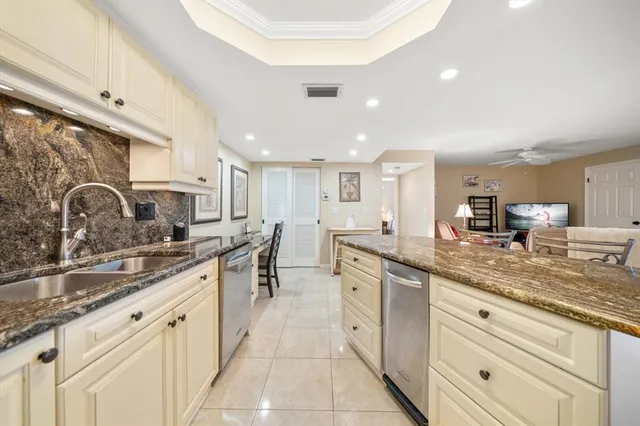 a bathroom with a granite countertop sink mirror and shower