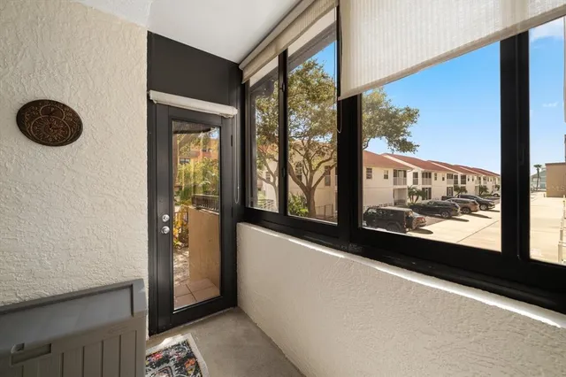 a view of a porch with furniture and garden view