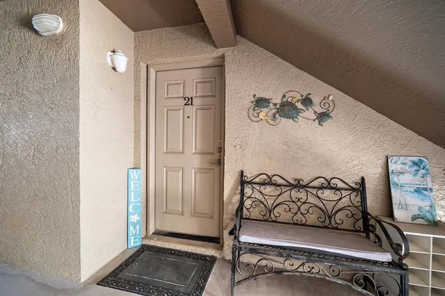 a kitchen with stainless steel appliances kitchen island granite countertop a refrigerator a stove a dining table and chairs