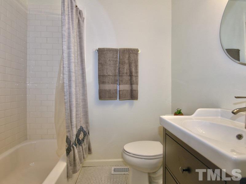 311 Colleton Road Raleigh, NC 27610 - Photo 14 of 22 a bathroom with a sink toilet and shower