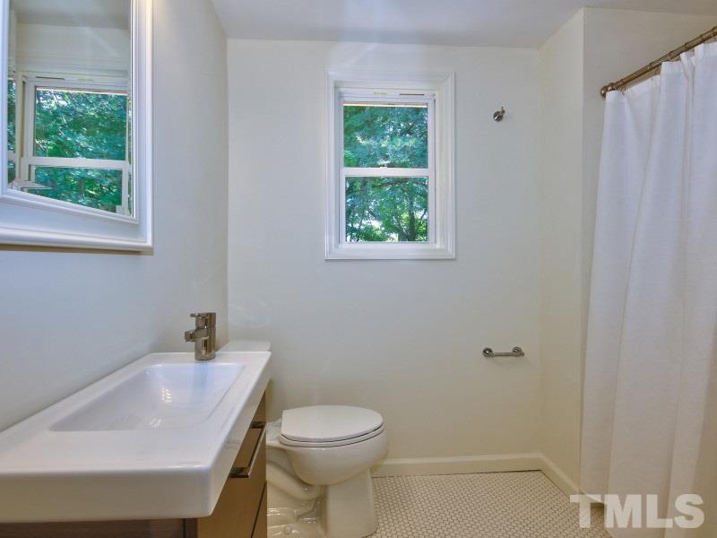 311 Colleton Road Raleigh, NC 27610 - Photo 17 of 22 a bathroom with a sink and a toilet