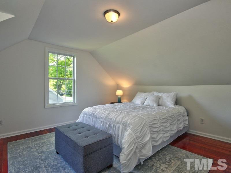 311 Colleton Road Raleigh, NC 27610 - Photo 18 of 22 a bedroom with a bed and a lamp on dresser