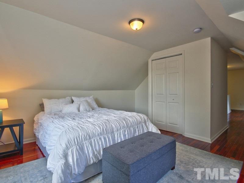 311 Colleton Road Raleigh, NC 27610 - Photo 20 of 22 a bedroom with a bed and wooden floor
