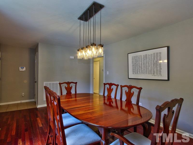 311 Colleton Road Raleigh, NC 27610 - Photo 4 of 22 a view of a dining room with furniture window and wooden floor
