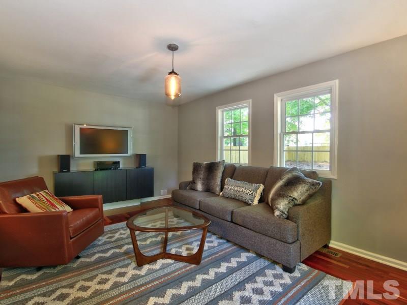 311 Colleton Road Raleigh, NC 27610 - Photo 9 of 22 a living room with furniture and a flat screen tv