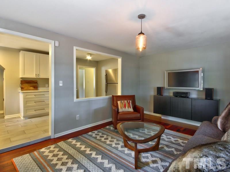 311 Colleton Road Raleigh, NC 27610 - Photo 10 of 22 a living room with furniture and a wooden floor