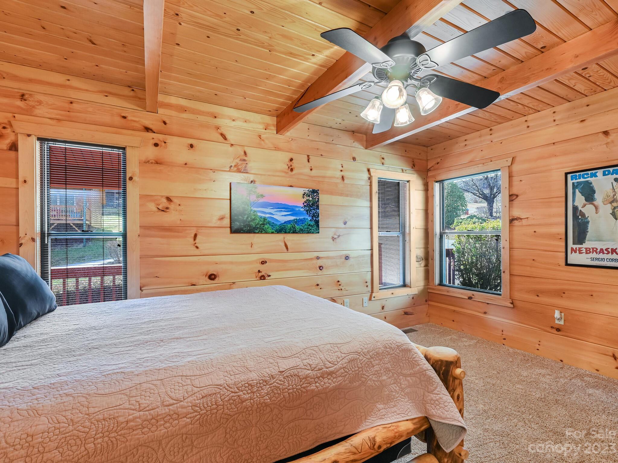 356 Panoramic Loop Maggie Valley, NC 28751 - Photo 12 of 24 a bedroom with a bed and a flat screen tv
