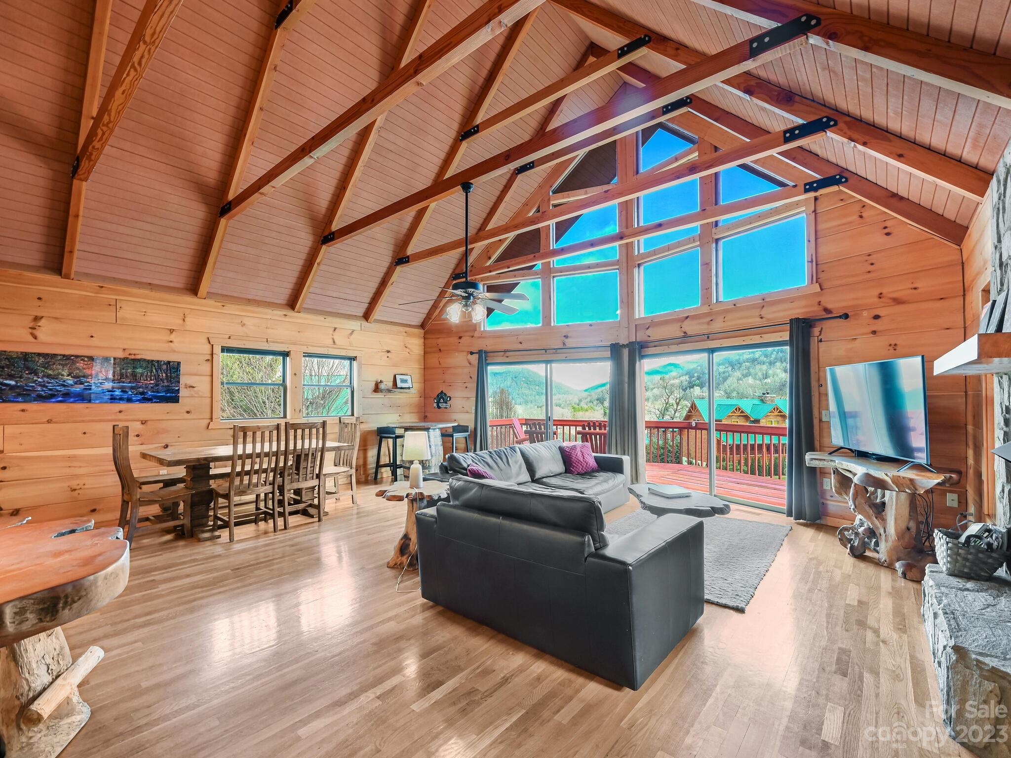 356 Panoramic Loop Maggie Valley, NC 28751 - Photo 5 of 24 a living room with furniture floor to ceiling window and wooden floor
