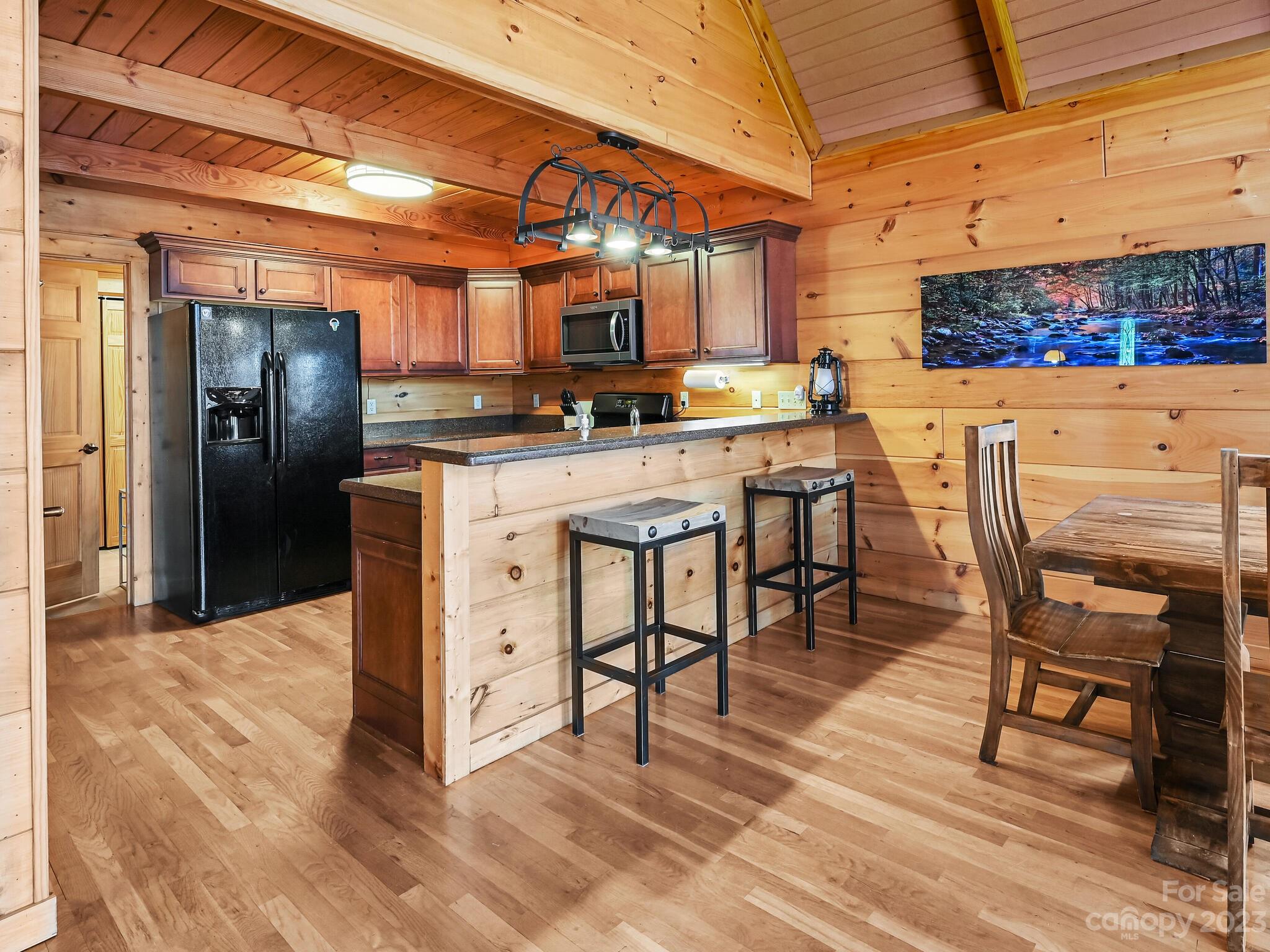 356 Panoramic Loop Maggie Valley, NC 28751 - Photo 8 of 24 a kitchen with stainless steel appliances kitchen island granite countertop a table chairs sink and cabinets