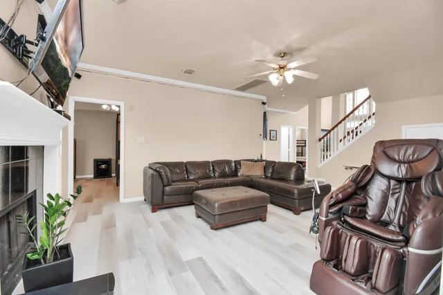 a living room with furniture a fireplace and a flat screen tv