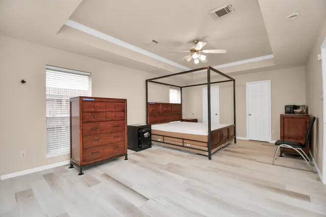 a bathroom with a granite countertop sink and a bathtub