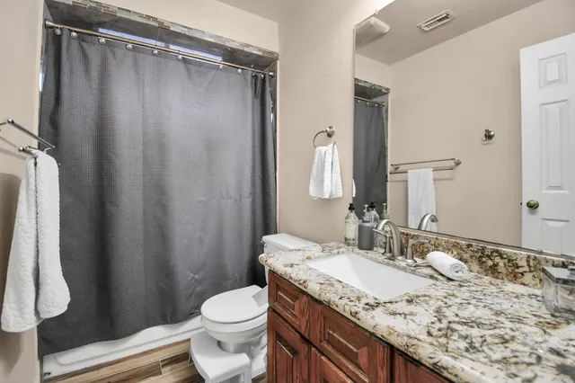 a bedroom with a bed and a large mirror