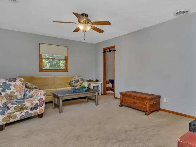 a living room with furniture and a chandelier