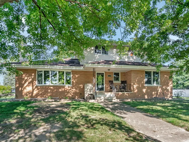 a view of a house with backyard sitting area and garden