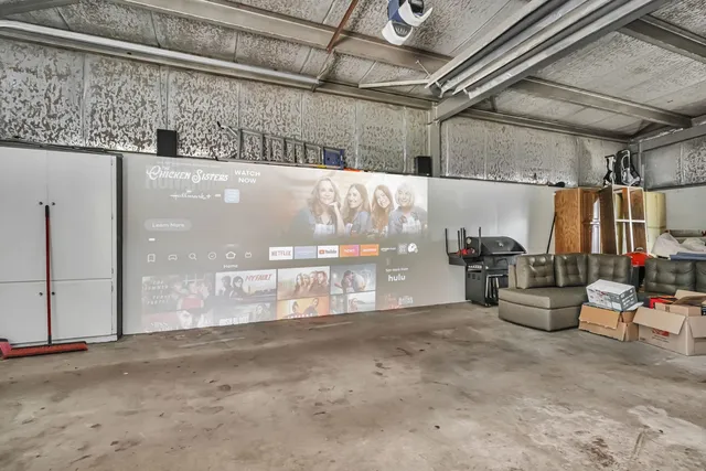 a front view of a house with a yard and garden