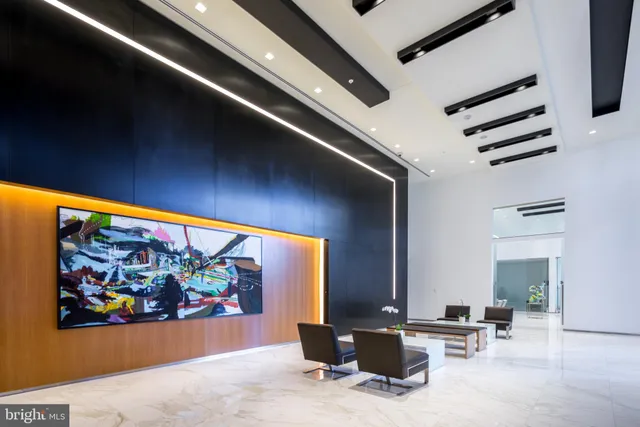 an outdoor space with patio furniture and painting on the wall