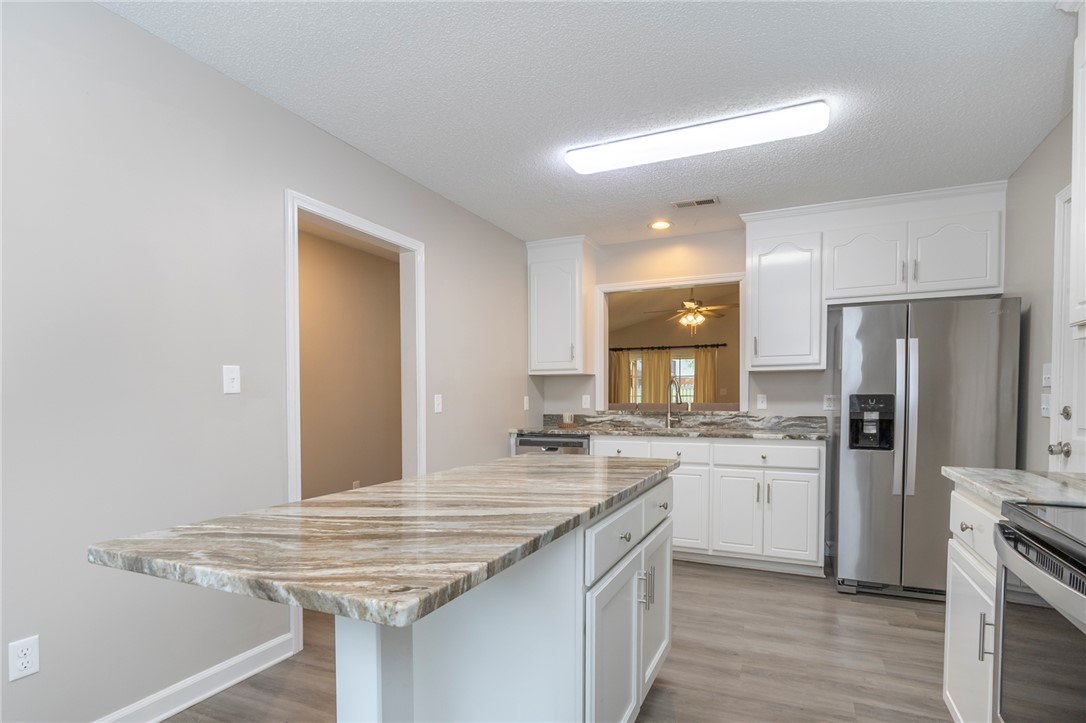 2509 Rolling Green Road Anderson, SC 29621 - Photo 3 of 28 A spacious kitchen features a central island, ample cabinetry, and sleek stainless steel appliances.