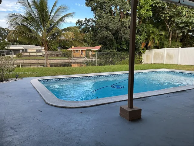 a view of a swimming pool with a patio