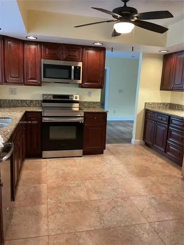 a large kitchen with stainless steel appliances and cabinets