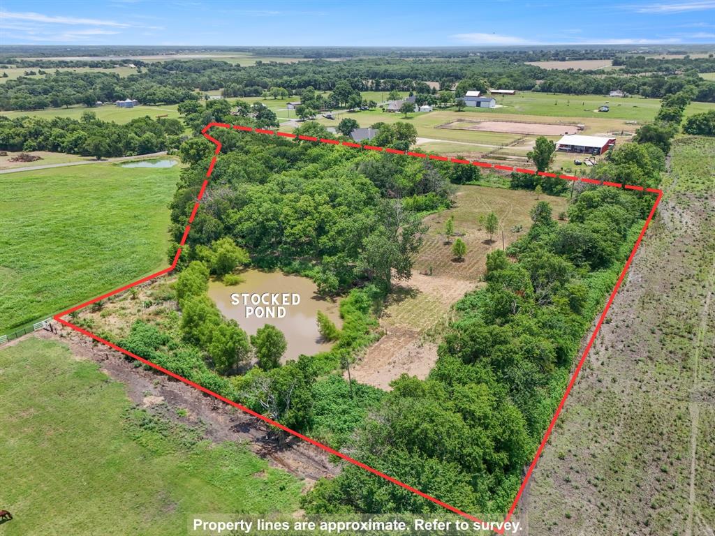 3165 Bennett Road Howe, TX 75459 - Photo 5 of 6 Property overview featuring the stocked pond, mature tree coverage, and approximate boundary lines.