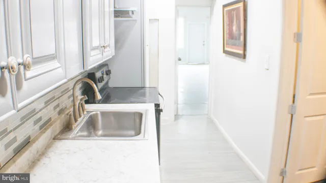 a kitchen with granite countertop a sink and a stove