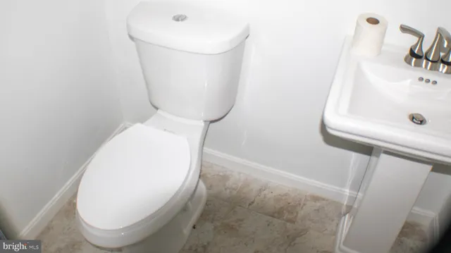 closeup of a sink with a toilet