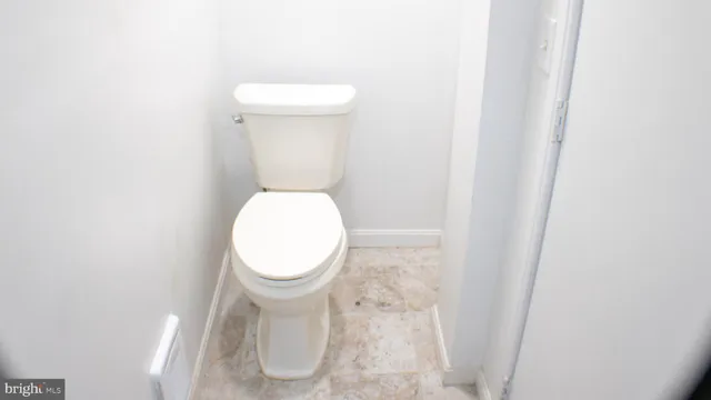 a kitchen with granite countertop a sink and dishwasher a refrigerator with wooden cabinets