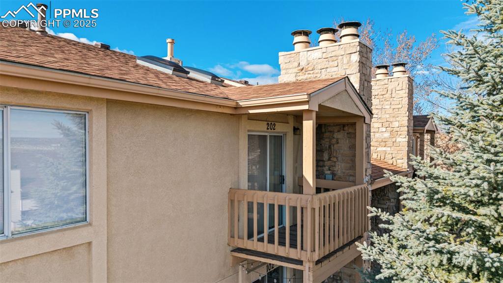 918 Tenderfoot Hill Road, Unit 202 Colorado Springs, CO 80906 - Photo 2 of 48 a view of a chair and table in the balcony