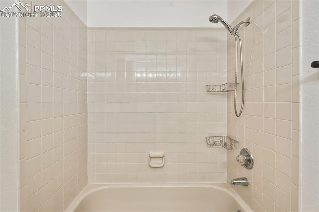 918 Tenderfoot Hill Road, Unit 202 Colorado Springs, CO 80906 - Photo 28 of 48 a bathroom with a shower and a bath tub