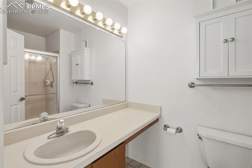 918 Tenderfoot Hill Road, Unit 202 Colorado Springs, CO 80906 - Photo 33 of 48 a bathroom with a sink a toilet and shower