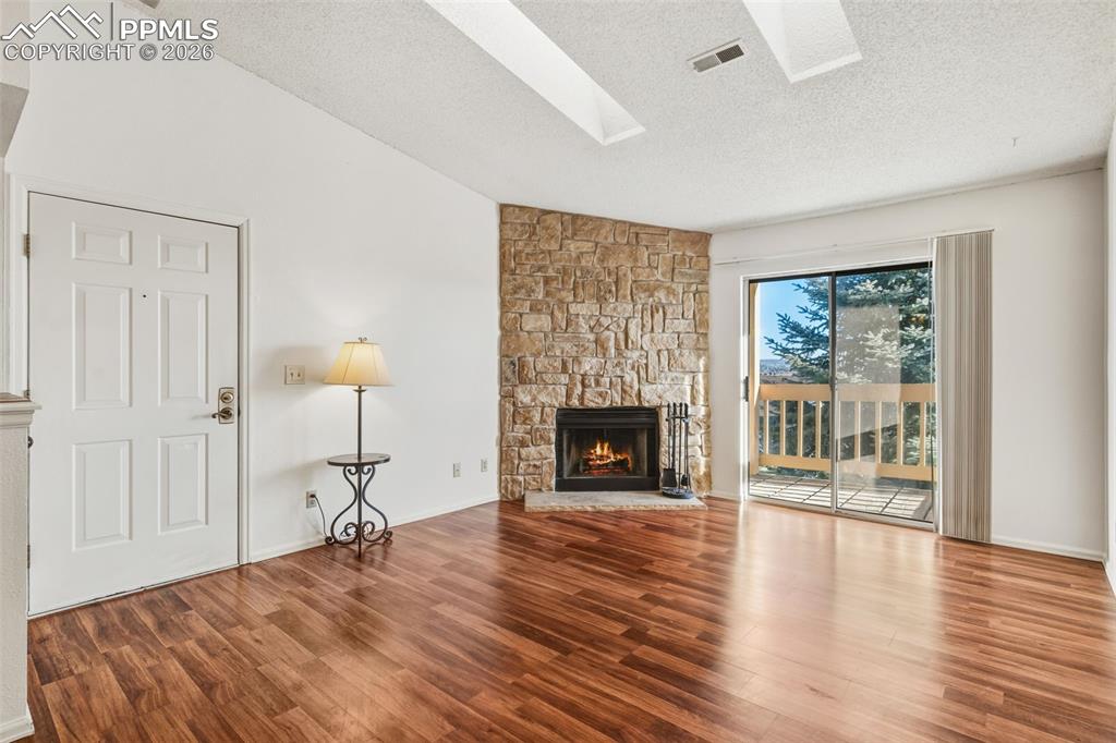 918 Tenderfoot Hill Road, Unit 202 Colorado Springs, CO 80906 - Photo 4 of 48 a spacious bedroom with a bed and a fireplace