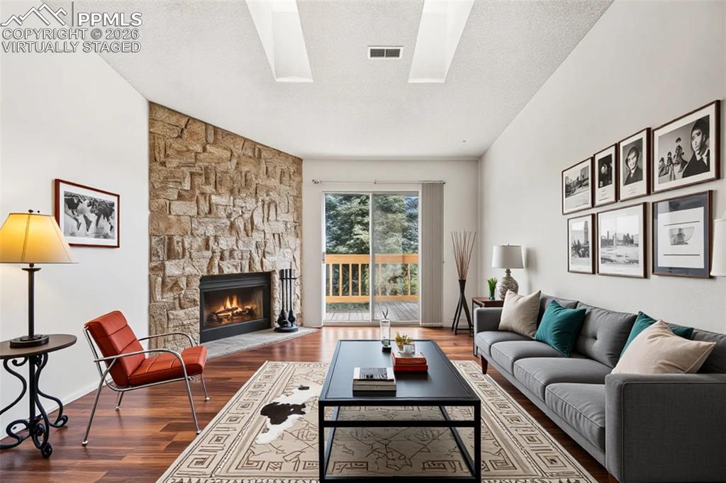 918 Tenderfoot Hill Road, Unit 202 Colorado Springs, CO 80906 - Photo 7 of 48 a living room with furniture and a fireplace