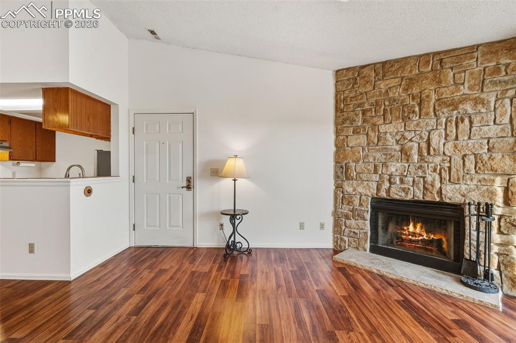 918 Tenderfoot Hill Road, Unit 202 Colorado Springs, CO 80906 - Photo 10 of 48 a view of empty room with wooden floor and fireplace