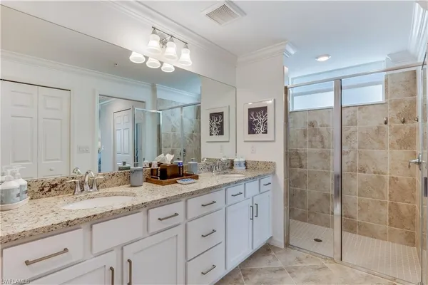 a bathroom with double sink and a mirror