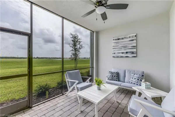 a living room with furniture and a floor to ceiling window