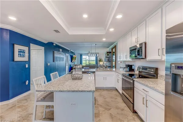 a kitchen with granite countertop stainless steel appliances and wooden cabinets