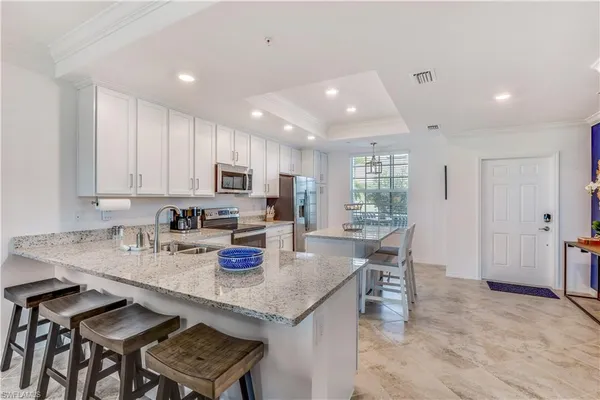a kitchen with stainless steel appliances granite countertop refrigerator sink and cabinets