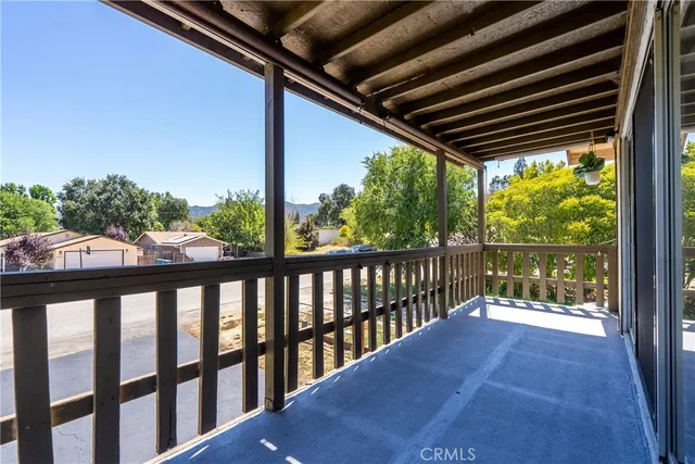 a view of a hardwood floor in a room with a kitchen