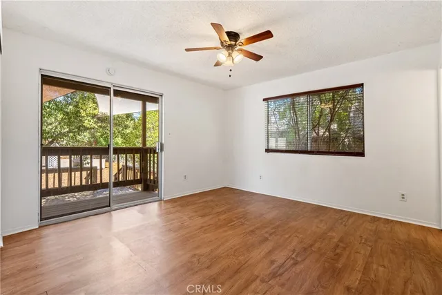 an empty room with fan and windows