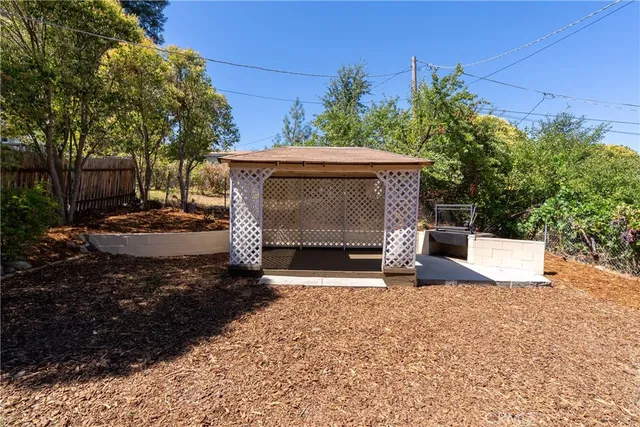 a view of a deck with wooden floor barbeque oven and outdoor seating