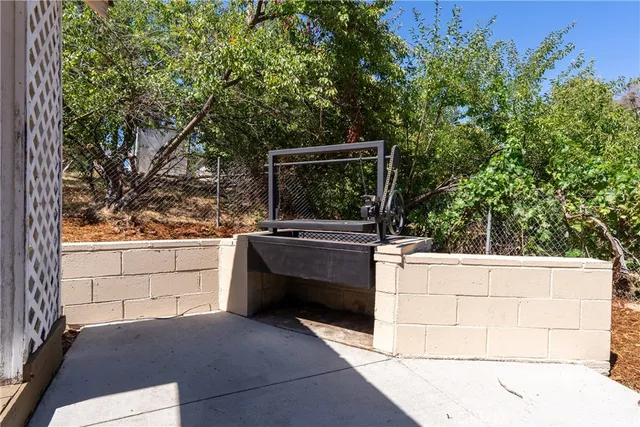 a view of a house with a yard and tree