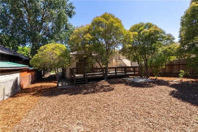 a front view of a house with garden and parking