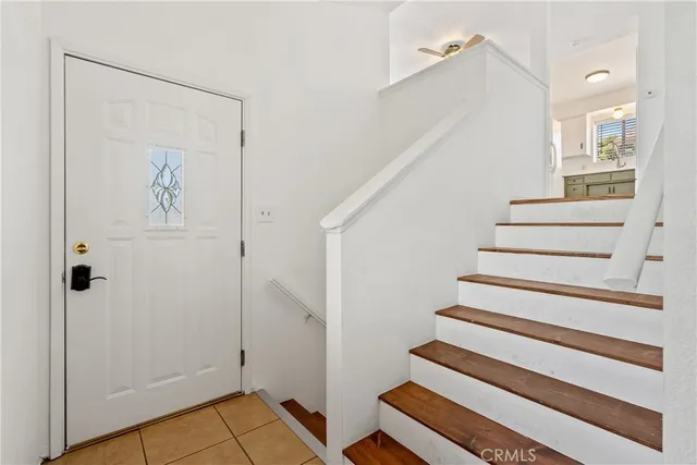 a view of entryway with wooden floor and stairs