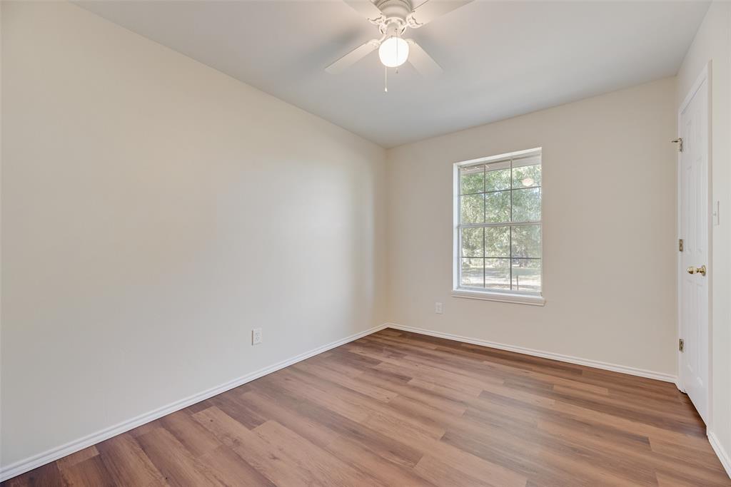 751 County Road 1240 Mount Pleasant, TX 75455 - Photo 25 of 35 an empty room with wooden floor and windows